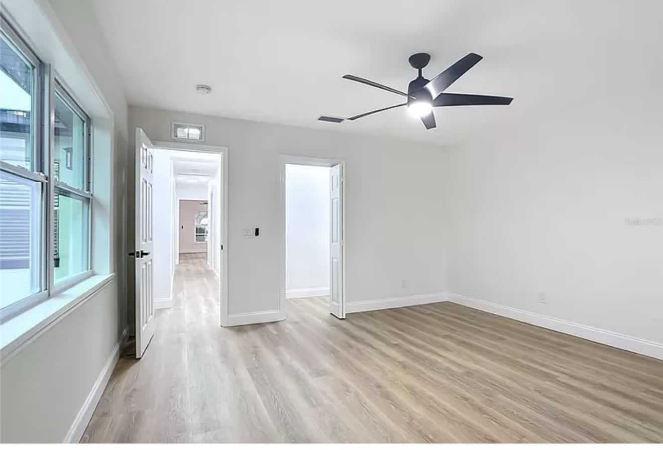 Remodeled room with replacement windows, finished doors, and clean white trim